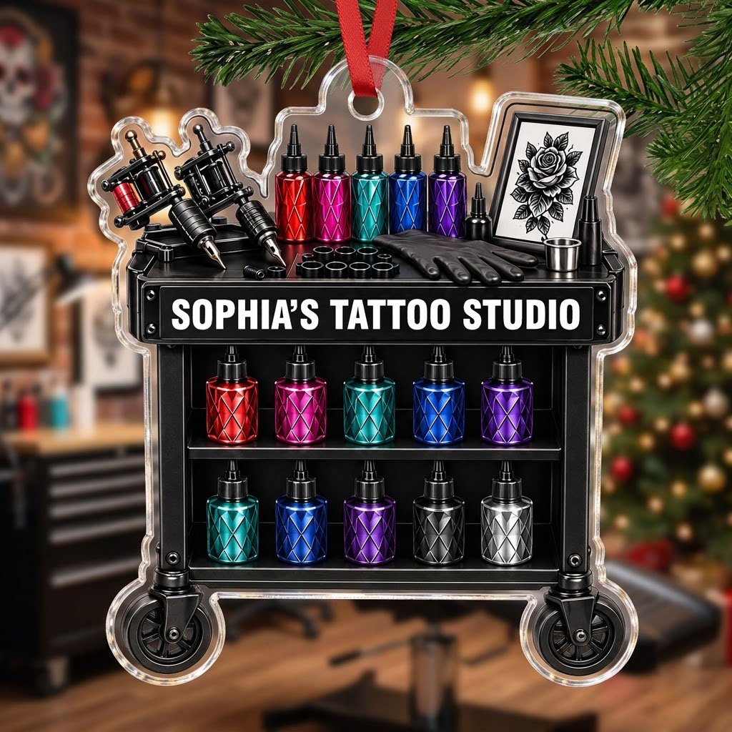 Acrylic ornament shaped like a tattoo cart with machines, colorful inks, and 'SOPHIA'S TATTOO STUDIO' text.