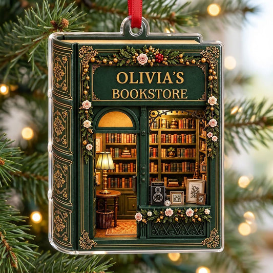 Dark green vintage bookstore storefront acrylic ornament with garland and shelves of books, reading 'OLIVIA'S BOOKSTORE'