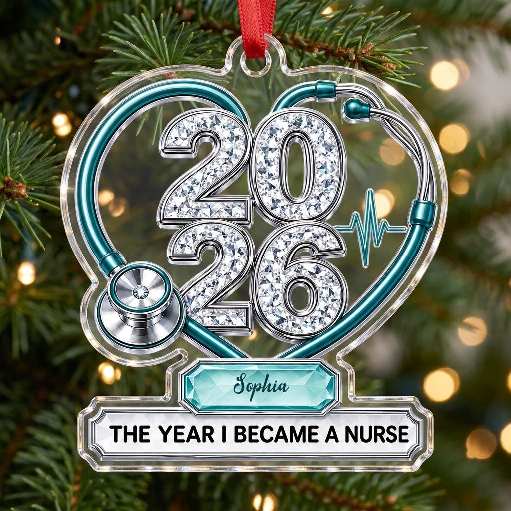Clear acrylic ornament with a teal stethoscope heart, diamond 2026 numerals, teal ECG wave, and a personalized name bann