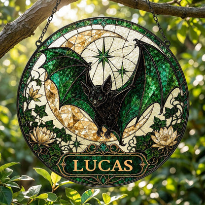 Round stained-glass style suncatcher with black bat, green wings, crescent moon, ivy, white flowers, and a personalized 