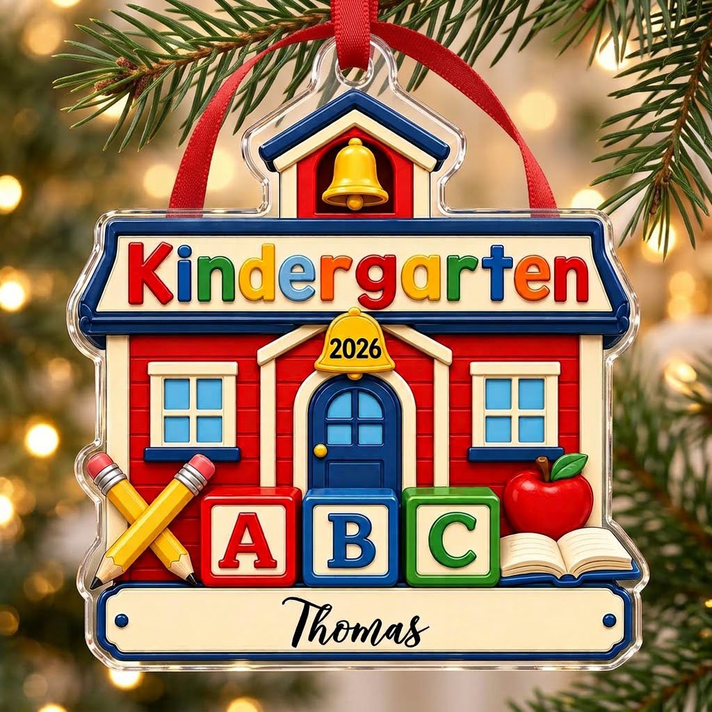 Red schoolhouse acrylic ornament with Kindergarten 2026, ABC blocks, pencils, apple, and a name on a white banner.