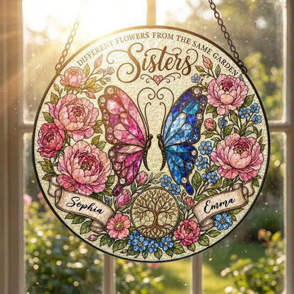 Round suncatcher with pink and blue butterfly, peony wreath, Tree of Life, and Sisters text with two name ribbons.