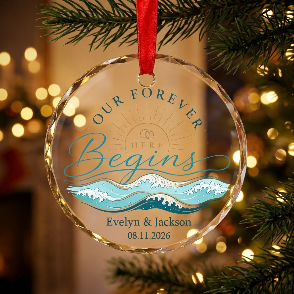 Round glass ornament with gold sun, interlocking rings, teal ocean waves, and 'OUR FOREVER HERE Begins' text.