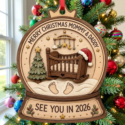 Snow globe wood ornament with crib, Santa hat, mobile, tree, footprints, and Merry Christmas Mommy & Daddy text.