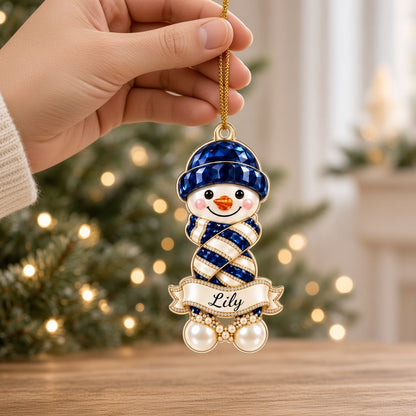 Custom-cut acrylic snowman ornament with jeweled hat and scarf, name banner, and faux pearl base.