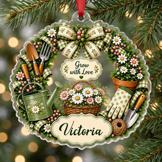 Scalloped acrylic ornament with a floral gardening wreath, tools, and "Grow with Love" plus a personalized name.