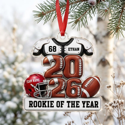 Acrylic ornament shaped like football gear with 2026 numbers, red helmet, ball and 'Rookie of the Year' nameplate.