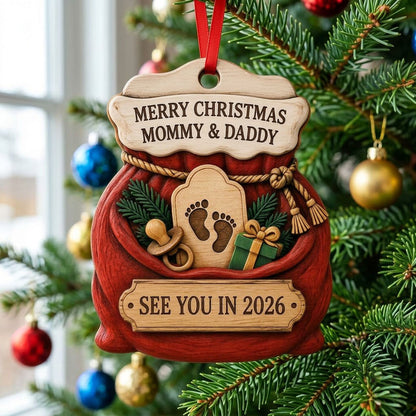 Red Santa sack wood ornament with rope tassels, baby footprints plaque, pacifier, and green gift box.
