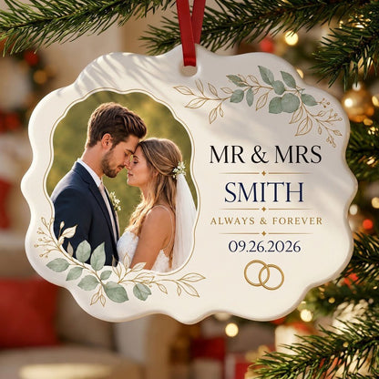 White scalloped ceramic medallion with MR & MRS, eucalyptus, gold rings, and a couple’s photo on the left.