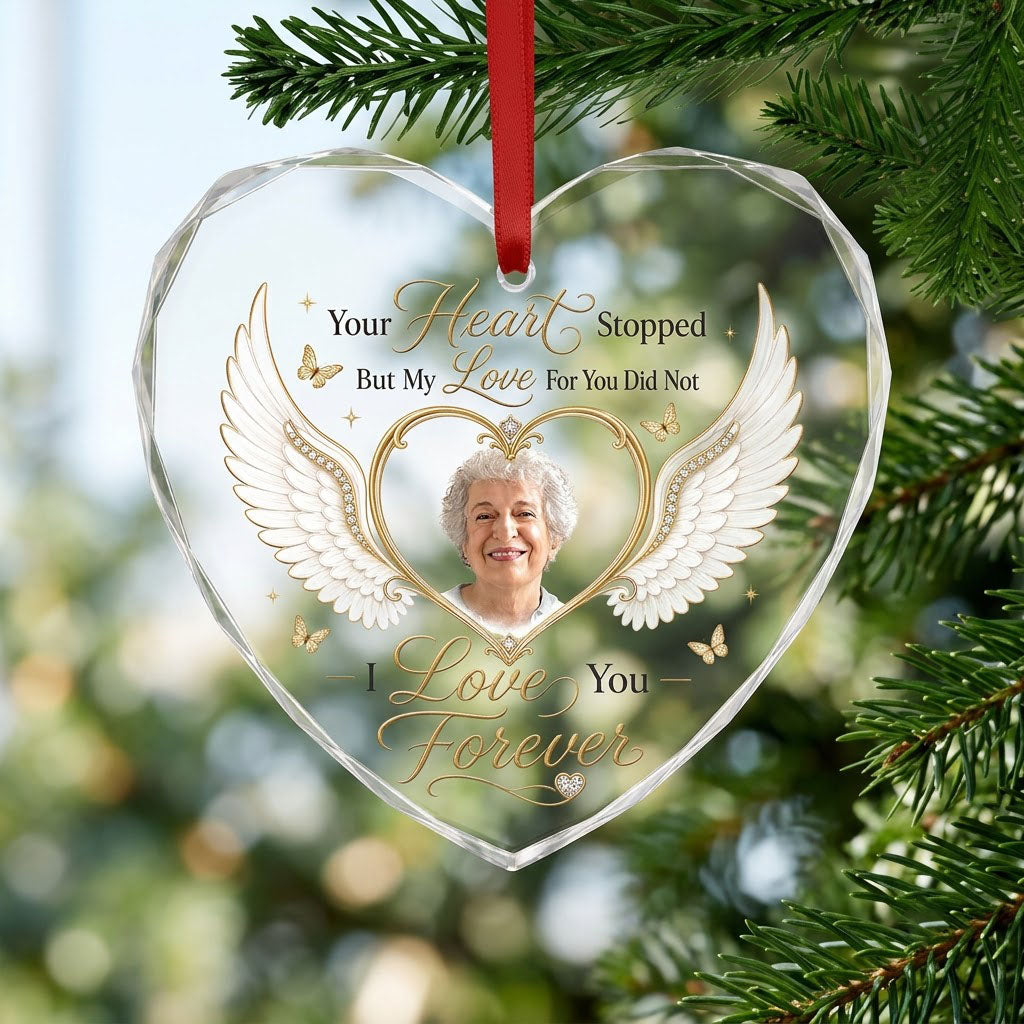 Heart-shaped glass ornament with white angel wings, gold heart photo frame, golden butterflies and sparkles.