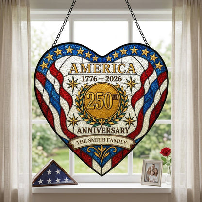 Heart suncatcher with red, white and blue stripes, gold medallion, laurel wreath, and 'America 1776–2026' text.