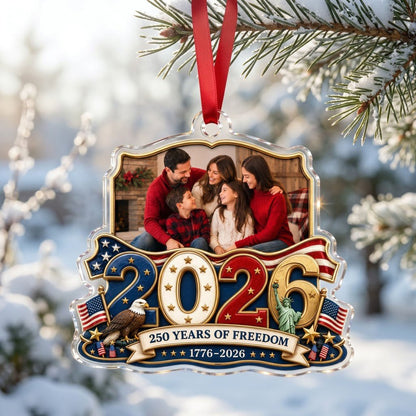 Custom-cut acrylic ornament with '2026', eagle, Statue of Liberty, flags and a gold photo frame.