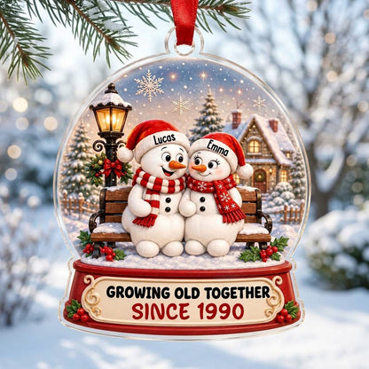 Acrylic snowglobe ornament with two snowmen on a bench, Santa hats, and Growing Old Together text.