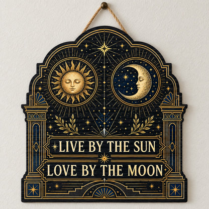Arched wooden sign with sun and moon faces, constellations, and 'Live By The Sun, Love By The Moon'.