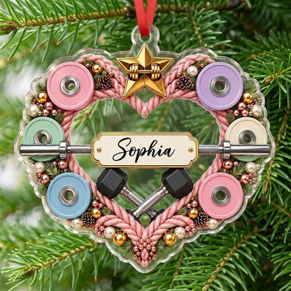 Clear acrylic heart ornament with pink rope wreath, pastel plates, barbell, crossed dumbbells, and a name plaque.