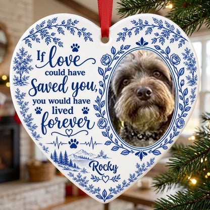 White heart ceramic ornament with blue dog photo frame wreath, memorial quote, paw heartbeat, and a mountain lake scene.