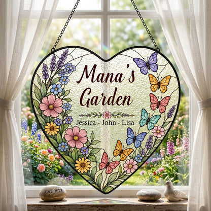 Heart stained-glass suncatcher with floral border, colorful butterflies, and 'Mana's Garden' with kids' names.