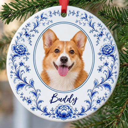 Round ceramic ornament with blue Delft floral border framing a circular photo of a dog and a personalized name.