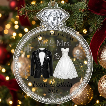 Clear acrylic diamond-ring ornament with tuxedo, lace gown, silver rings and 'First Christmas as Mr. & Mrs.' text.