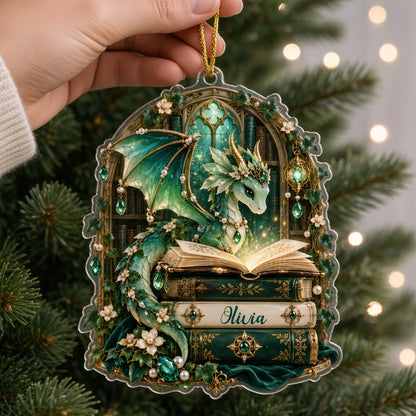 Emerald green dragon with gold-accented wings on vintage books, name Olivia, stained-glass arch acrylic ornament.