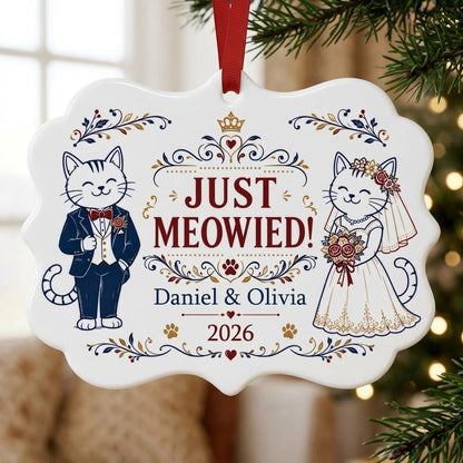 Medallion ceramic ornament with cat bride and groom, gold crown, floral scrolls, red hearts and paw prints on white.