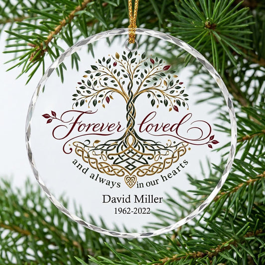 Round glass ornament with Celtic Tree of Life in green, gold and red, reading Forever loved and always in our hearts.