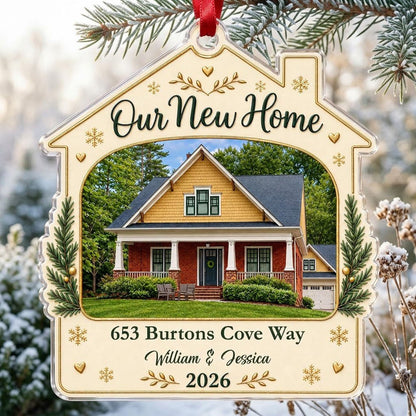 House-shaped acrylic ornament with “Our New Home”, a house photo frame, pine boughs, gold hearts and snowflakes.