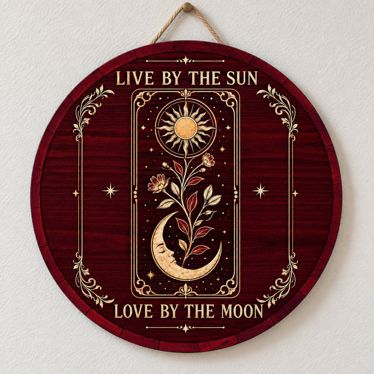 Round wooden sign with tarot-style sun and sleeping moon, floral vine, stars, and the words Live by the Sun, Love by the