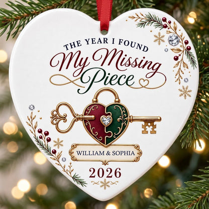 Heart ceramic ornament with a gold key through a burgundy and green heart lock, pine sprigs, berries, and gold snowflake