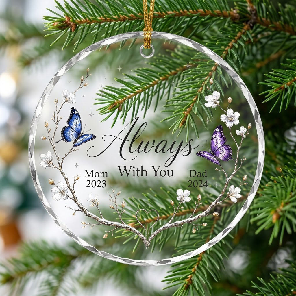 Round glass ornament with branch wreath, white blossoms, blue and purple butterflies, and Always With You text.