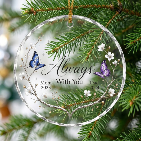 Round glass ornament with branch wreath, white blossoms, blue and purple butterflies, and Always With You text.