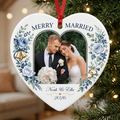 Heart ceramic ornament with “MERRY & MARRIED,” dusty blue florals, wedding bells, rings, and a heart-shaped photo frame.