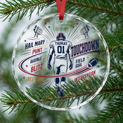 Round faceted glass ornament with football player back view, stadium lights, navy swoosh, and name and number.