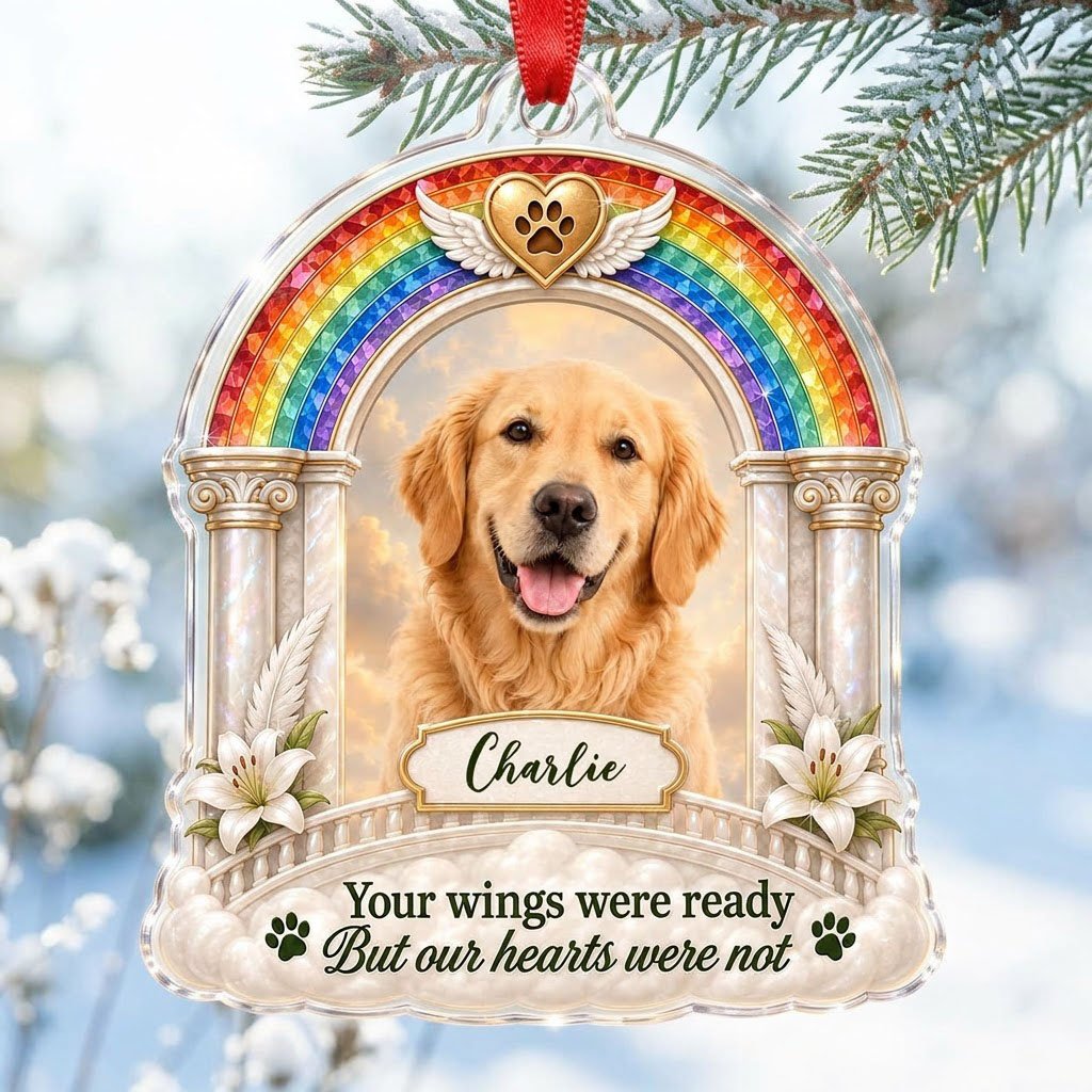 A rainbow arch pet memorial acrylic ornament with a winged golden heart, paw print, lilies, pillars, clouds and a photo 