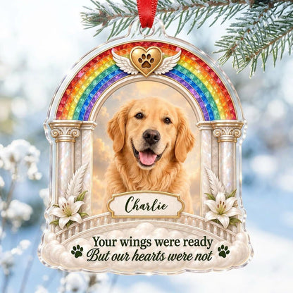 A rainbow arch pet memorial acrylic ornament with a winged golden heart, paw print, lilies, pillars, clouds and a photo 