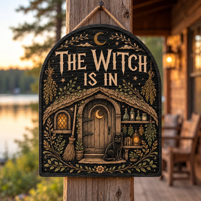 Arch wood sign with "THE WITCH IS IN", witch cottage, black cat, broom, herbs and lantern details.