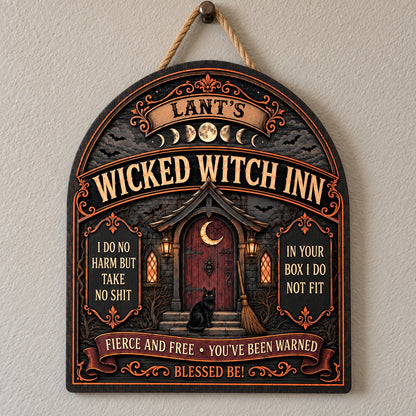 Arch wooden sign with a witch's cottage, bats, moon phases, red crescent door, broom, and a black cat on the steps.