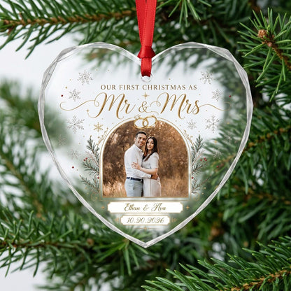 Heart-shaped glass ornament with photo, gold wedding rings, pine branches, snowflakes, and Mr & Mrs text.