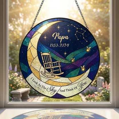 Round stained-glass suncatcher with a crescent moon, rocking chair, fireflies and a memorial banner.