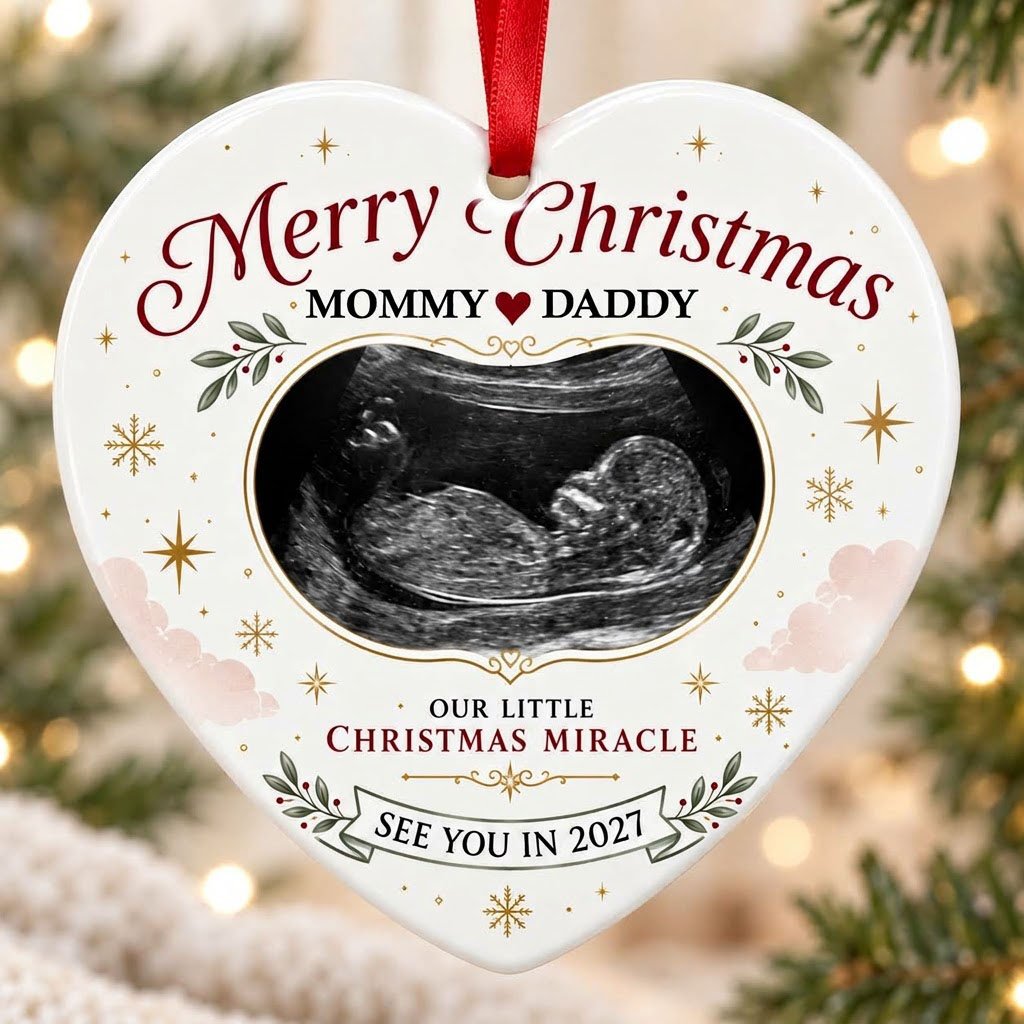 Heart ceramic ornament with ultrasound photo, gold starbursts, green leaves with red berries, and a bottom banner.