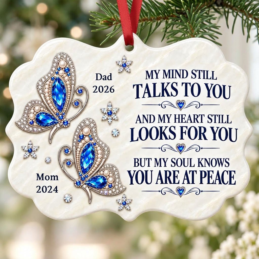 Scalloped ceramic ornament with two blue jeweled butterflies, silver starburst flowers and a memorial quote.