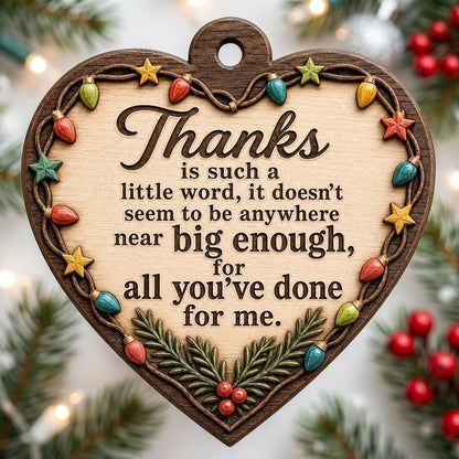 Heart-shaped wood ornament with a lights-and-stars border, pine sprigs with red berries, and a gratitude quote.