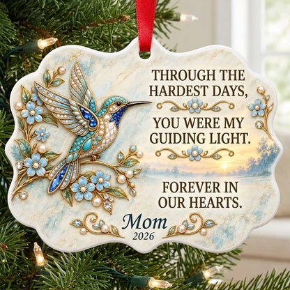 Ceramic medallion ornament with a jewel-encrusted blue bird, blue flowers, gold filigree, and a sunrise lake background.