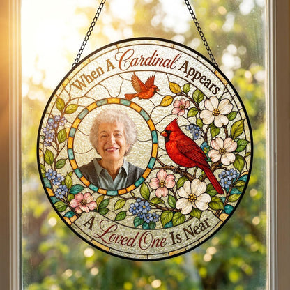 Round faux stained-glass suncatcher with two red cardinals, dogwood flowers, and a left-side circular photo frame.