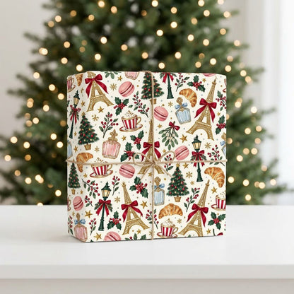 Cream paper with gold Eiffel Towers, Christmas trees, street lamps, macarons, croissants, holly and stars pattern.