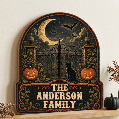 Arched wooden sign with crescent moon, bats, wrought-iron gate, black cat and jack-o'-lanterns with family name.