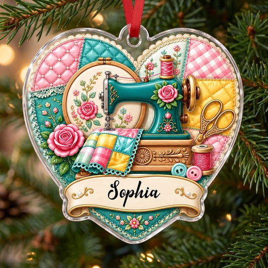 Heart-shaped acrylic ornament with a teal sewing machine, quilt, scissors, roses and a name banner at the bottom.