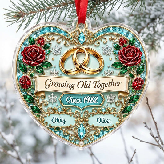 Heart-shaped clear acrylic ornament with golden rings, red roses, “Growing Old Together,” and custom names with a since 
