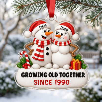 Custom-cut acrylic ornament of a snowman couple with candy cane, gift box, and Growing Old Together text on a snowy base
