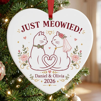 Two white cats with bow tie and bridal veil under JUST MEOWIED with roses and stars on a heart ceramic ornament.